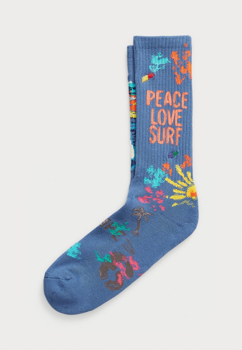 Blue cotton socks with ribbed texture, featuring multicolored floral and surf-themed patterns, and the phrase "PEACE LOVE SURF" in orange.