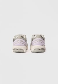 Buty do biegania w jasnoszarym i lawendowym zestawie kolorów. Siatkowa cholewka, wyściółka z amortyzacją w pięcie oraz gumowa podeszwa o teksturowanej powierzchni.