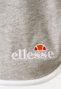 Felpa grigia con una texture morbida, caratterizzata da un logo ricamato bianco "ellesse" e da una grafica multicolore sopra di esso, bordata di bianco.