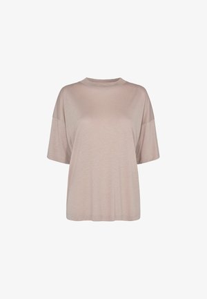 T-shirt oversize beige à manches courtes avec un col rond et une coupe ample présenté sur fond blanc.