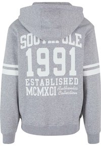 Grå hættetrøje med en frontlomme; har hvid tekst, der siger "SOUTH POLE 1991 ETABLEREDE MCMXCI Authentisk Kollektion" og stribede ærmer.