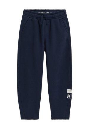 Marineblaue Jogginghose mit elastischem Bund, Kordelzug, Seitentaschen und zwei weißen und schwarzen Label-Patches am Unterschenkel.