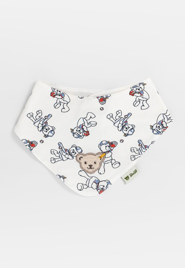 Weißes Baumwoll-Lätzchen mit wiederholten Cartoon-Bärenmotiven, einem weichen, gestickten Bären in der Mitte und einem grünen Etikett am unteren Ende.