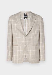 Beżowa marynarka w jasny wzór w kratkę, z klapami w kształcie litery notch, dwoma guzikami, dwiema przednimi kieszeniami oraz rozcięciem z tyłu. Metka widoczna wewnątrz.