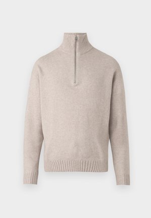 Pull en tricot beige à fermeture éclair quart, fabriqué dans un tissu doux. Présente un col et des poignets côtelés, avec une coupe décontractée et un design sans coutures.