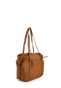 Brown leather tote bag with studded accents, rounded shape, two long straps, and a zippered pocket at the front.