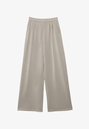 Beżowe spodnie o szerokich nogawkach z elastycznym pasem, zapięciem na guzik, bocznymi kieszeniami i subtelnymi plisami.