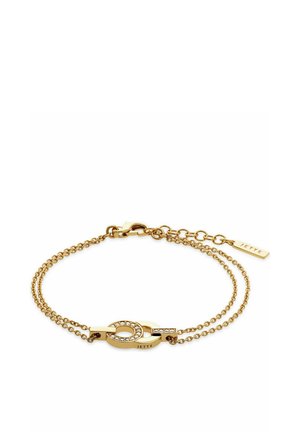 Gouden armband met twee verbonden schakels. Heeft een ovale hanger met heldere stenen en een klein label met de gravure "JETTE."