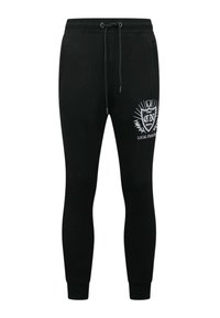 Zwarte katoenen sweatpants met een slim fit, voorzien van een trekkoord in de taille en een witte bedrukte logo en tekst op het linkerdij.