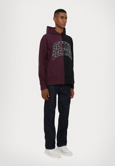 Hooded sweatshirt in dark purple and black, featuring "BETTER 2GETHER" text, kangaroo pocket, and relaxed fit. Paired with dark jeans and white sneakers.