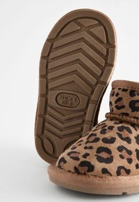 Brun leopardmönstrad stövel med en mjuk mockaöverdela, texturerad gummisula med ett zigzagmönster och stoppning kring vristen för komfort.