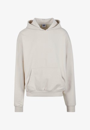 Jasnobeżowa bluza z kapturem z kieszenią na przodzie, regulowanym kapturem, ściągaczami na rękawach i luźnym krojem. Wykonana z miękkiego, teksturowanego materiału.