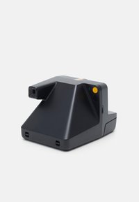 Black instant camera with a triangular design, featuring a yellow power button, lens, and small colored stripes on the top.