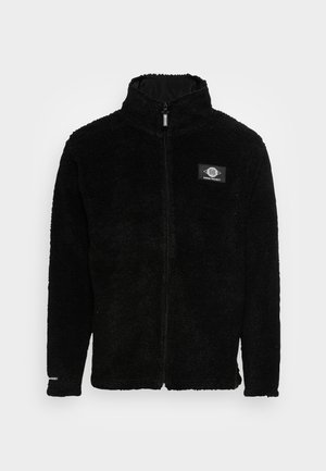 Black fleece jacket with a high collar, front zip closure, and a branded rectangular patch on the left chest. Soft, textured surface.