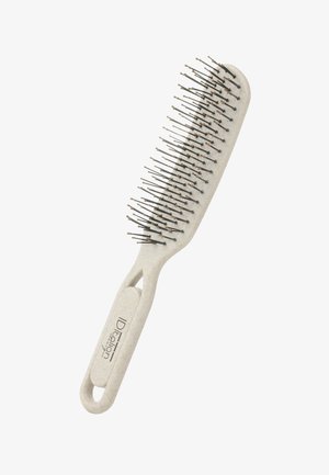 Cepillo de pelo beige con púas metálicas rematadas con pequeños extremos redondeados y un mango ergonómico etiquetado como "IDealion."