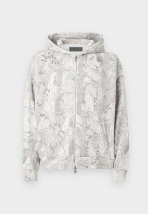 Sweat à capuche gris clair avec un motif inspiré de la nature. Comprend une fermeture éclair devant, deux poches et des poignets côtelés. Texture douce.