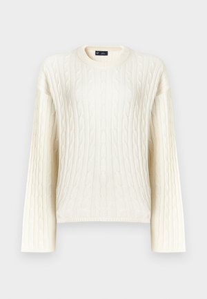 Pull crème à torsades avec manches longues, col rond et motif texturé. Confectionné dans un tissu doux et tissé.