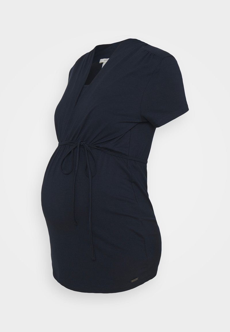 Marinblus för gravida med korta ärmar, V-ringning och justerbar dragsko vid midjan. Tillverkad av mjukt, elastiskt material.