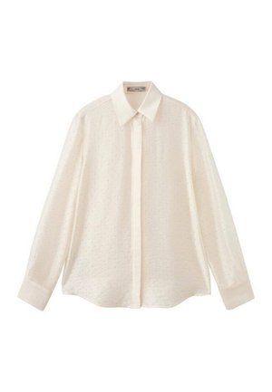 Chemise blanche à manches longues à boutons avec un col classique, présentant un tissu texturé avec de petits motifs de points et des manches à boutons.