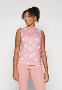 Pink sleeveless polo top with a floral pattern, button-up collar, and CK logo, made from a smooth, stretchy material.