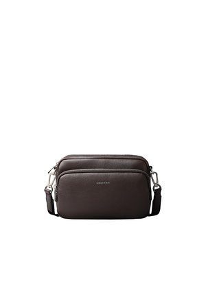 Dark brown leather crossbody bag with two zippered compartments and adjustable strap, featuring small Calvin Klein logo on front pocket.