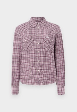 Chemise à carreaux violette et rose avec un col, deux poches poitrine et des manches longues. Fabriquée dans un tissu à motif de carreaux.
