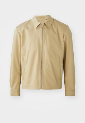 Beige lightweight jacket with a collared neck, front zip closure, and two side pockets. Smooth texture and relaxed fit.