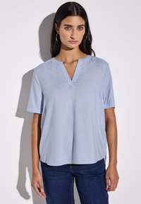 Blusa a maniche corte di colore blu chiaro con scollatura a V e risvolti, realizzata in tessuto morbido, con una vestibilità comoda e orlo dritto.