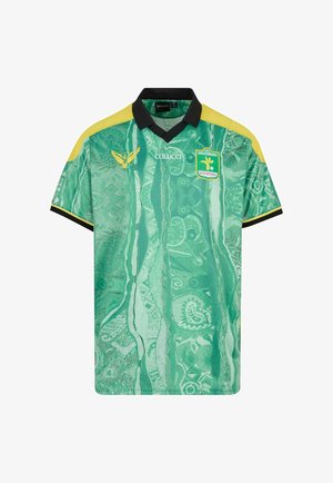 Roheline ja kollane jalgpallijerseys musta kraega, mustriline kangas, Colucci logo ja Fussballclub Kitzbühel vapp rinnal.