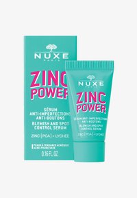 En blemish kontrol serum i en turkos tub med ett räfflat lock, med fet rosa text som säger "ZINC POWER" på framsidan.