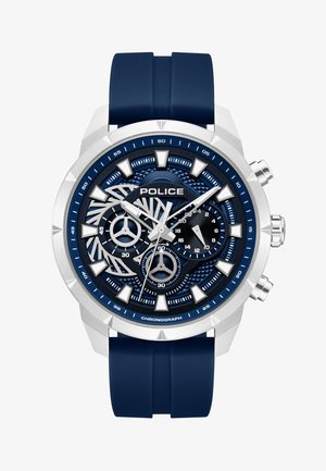 Orologio da polso cronografo blu e argento con tre quadranti secondari, marcatori delle ore triangolari e audaci, e cinturino in silicone blu.