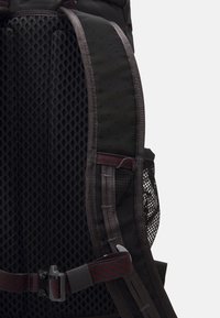 Black backpack with padded, breathable mesh back; features adjustable straps and a buckle. Textured surface with red accents.