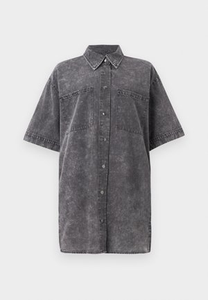 Gray denim oversized shirt with short sleeves, front button closure, two chest pockets, and a faded texture. Classic collar design.