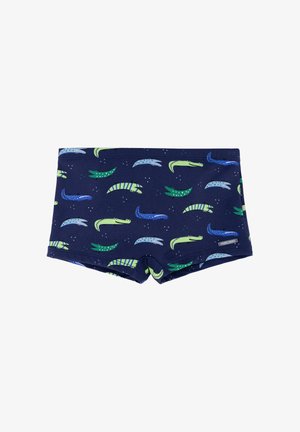 Bañador para niños en azul marino con patrones coloridos de cocodrilos en verde, azul y azul claro, pequeña etiqueta de la marca en el lateral.