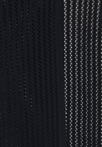 Svart tyg med två distinkta texturer: den ena sidan är heltäckande utan mönster, medan den andra har en nätliknande design med diamantformade öppningar.