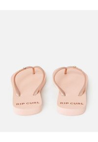 Infradito rosa in gomma con suola piatta. Presentano cinturini sottili e il testo "RIP CURL" impresso sulla soletta.