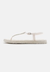 White flip-flop sandal with braided fabric sole, clear plastic thong strap, and a metallic accent. Simple, flat design.