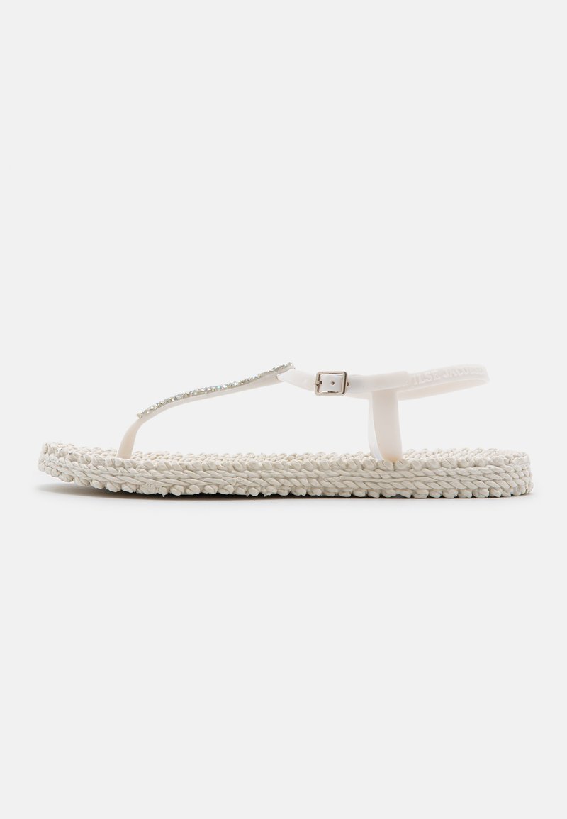 White flip-flop sandal with braided fabric sole, clear plastic thong strap, and a metallic accent. Simple, flat design.