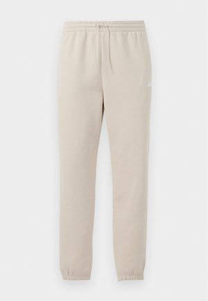 Pantaloni della tuta beige chiaro realizzati in tessuto morbido, con una vita elastica, un cordoncino regolabile e polsini a vite alle caviglie.