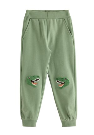 Grønne børnesweatpants med elastik i talje og manchetter, med teksturerede dinosaurhoveder som patches på hvert knæ.