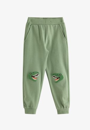 Grønne børnesweatpants med elastik i talje og manchetter, med teksturerede dinosaurhoveder som patches på hvert knæ.