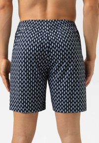 Marineblauwe zwembroek met een herhaald lichtblauw nautisch patroon, een elastische tailleband en een ontspannen pasvorm, voorzien van zijzakken en een gladde textuur.