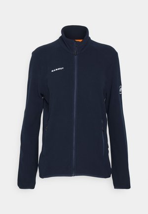 Navy blue fleece jacket with full zip, high collar, two side pockets, and white logo on the chest. Smooth texture and lightweight design.