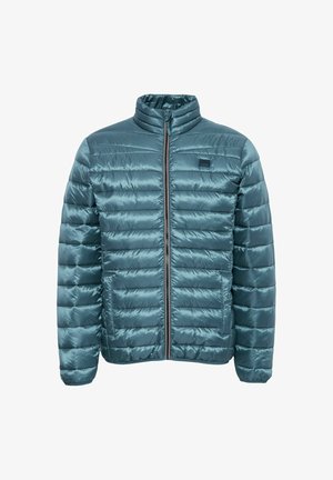 Teal pufferjakke med højt krave, vandret quiltet tekstur, lynlås foran og et lille logo-patch på venstre bryst.