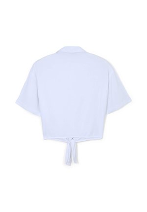 Camicia bianca corta in tessuto liscio, con maniche corte, collo e dettaglio annodato nel dietro all'orlo inferiore.
