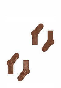 Braune Socken mit einer strukturierten Oberfläche und weißen Punkten, erhältlich in knöchellanger und normaler Länge. Material aus Baumwollmischung.