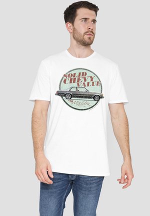 White cotton T-shirt featuring a vintage-style graphic of a black car with text "Solid Chevy Value" and "78 Malibu" in red and teal.