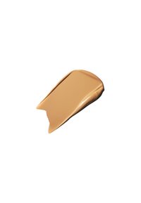 Crème cosmétique beige en forme allongée et lisse avec un bord légèrement courbé ; texture brillante avec une finition mate.