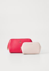 Two textured leather Furla pouches, one large red and one smaller light pink, both with gold zipper and logo.