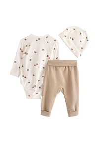 Ensemble de vêtements pour bébé comprenant un body à manches longues blanc avec des pois marron, un pantalon beige et un bonnet assorti, le tout en doux coton.